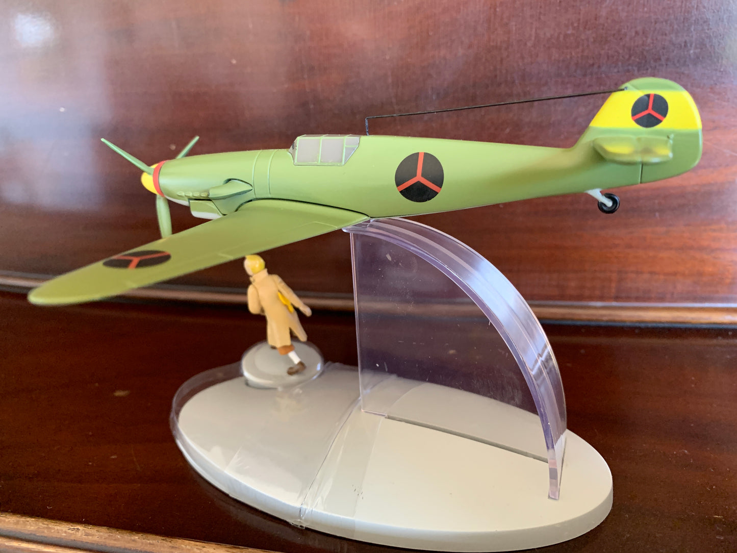 Messerschmitt Bf109 model from Tintin's King Ottokar's Sceptre, green with emblems, on display stand with figurine