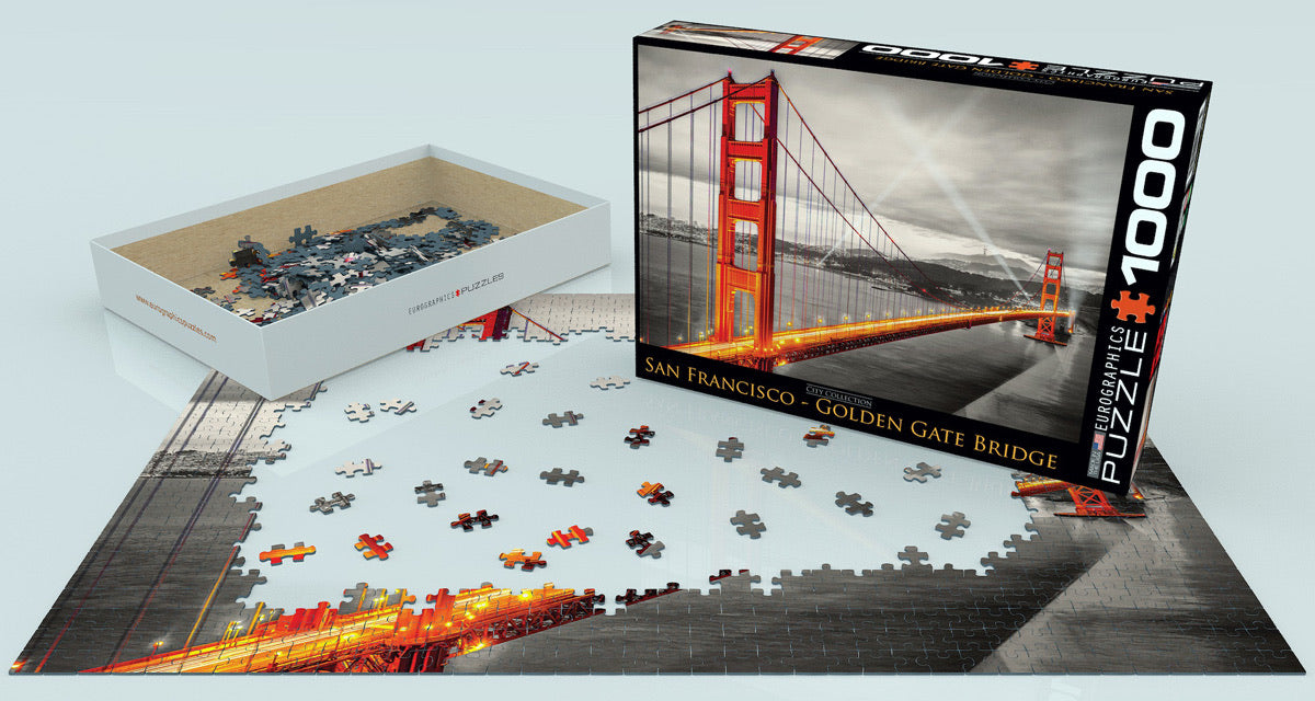 1000-piece Golden Gate Bridge puzzle box with partially completed puzzle, showing iconic San Francisco landmark at night
