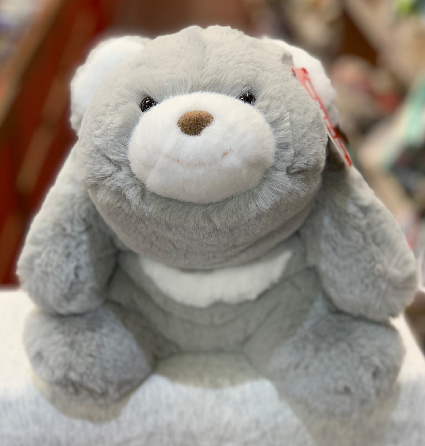 Gund Snuffles teddy bear plush toy with crescent moon design, soft gray fur, and white muzzle, sitting upright