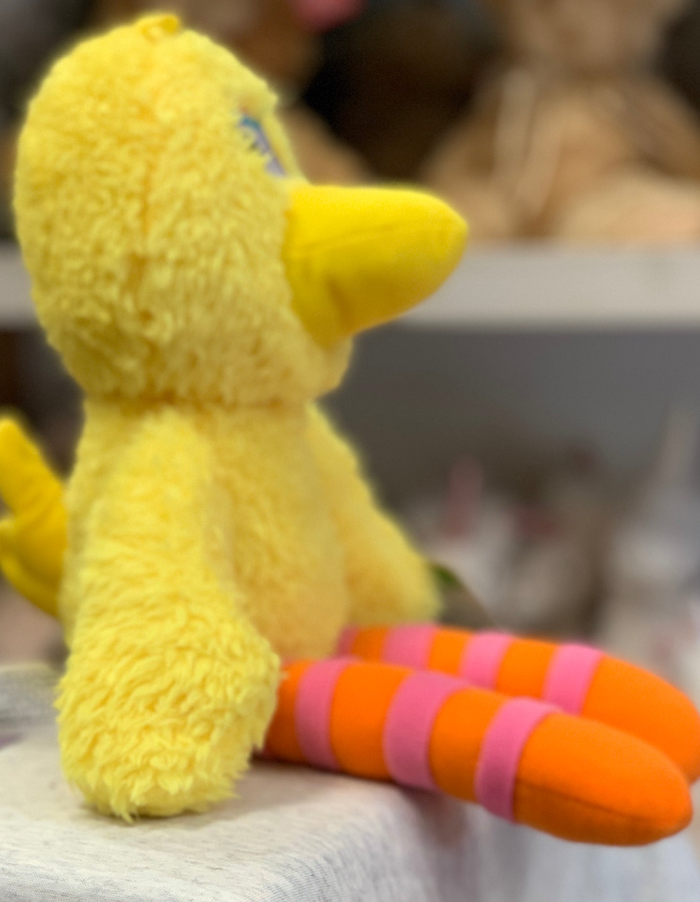 Gund Sesame Street Big Bird plush toy with soft yellow body and colorful striped legs, perfect for hugging and take-along adventures