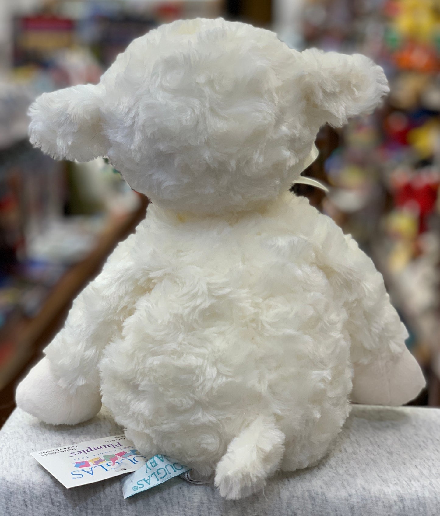 Soft white Douglas Lamb Plumpie plush toy, viewed from behind, showcasing fluffy texture and infant-safe design