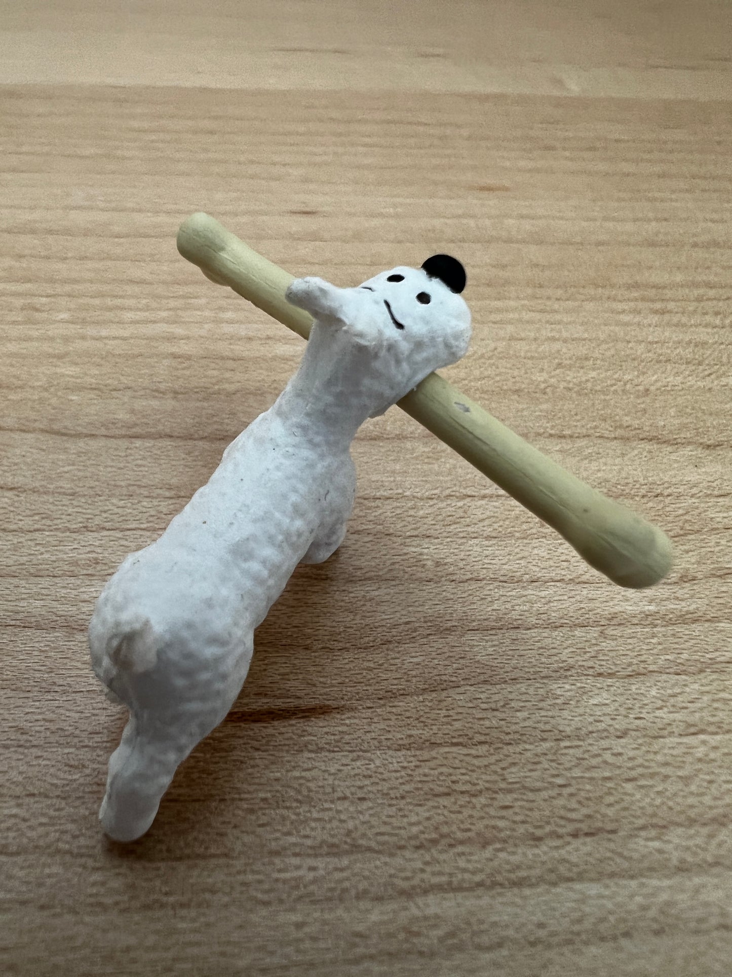 Tintin's dog Snowy figurine carrying large camel bone, from The Crab With Golden Claws adventure