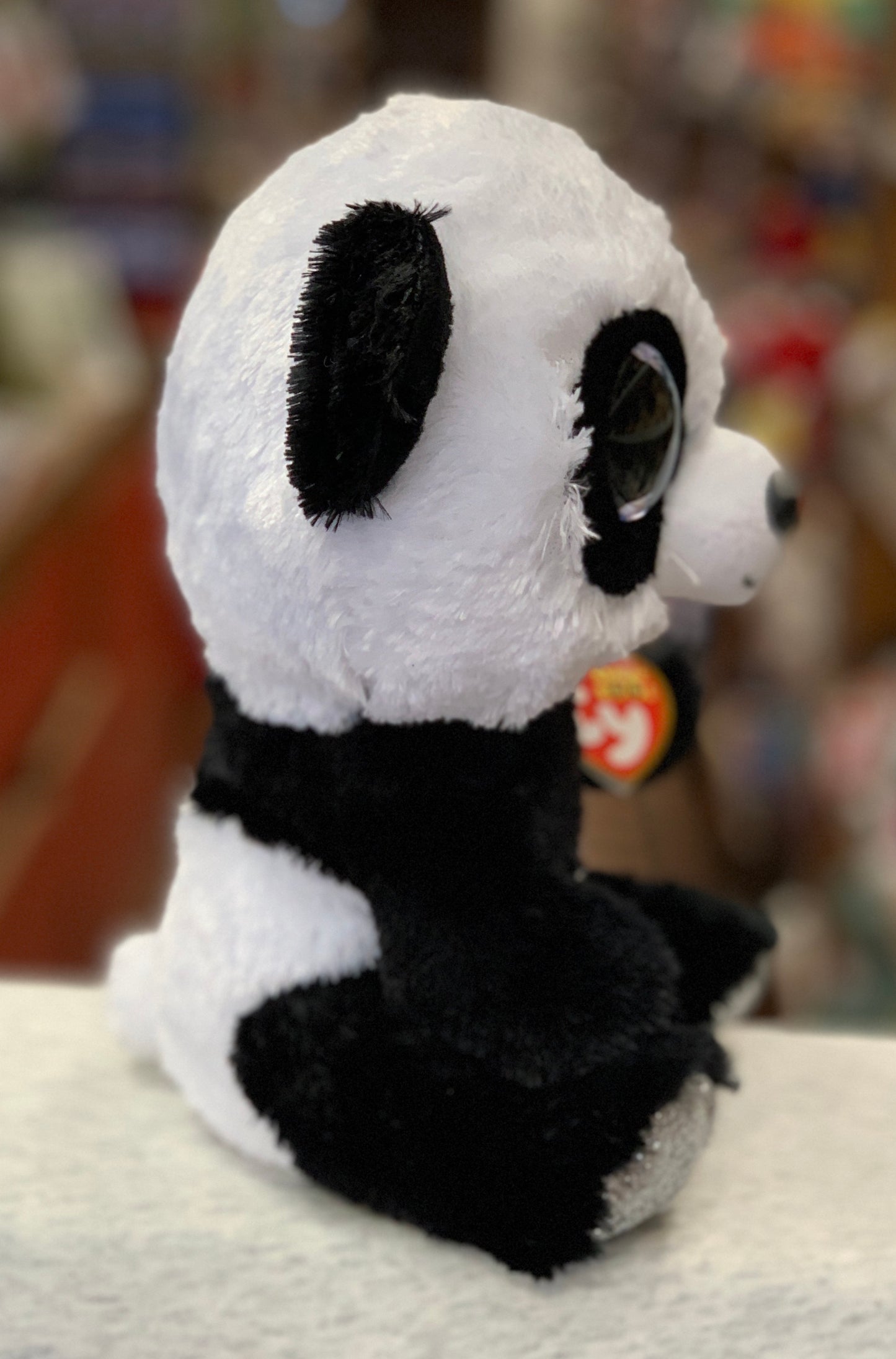 Adorable Ty Beanie Boo panda plush toy with large eyes, soft white and black fur, perfect for cuddling and collecting