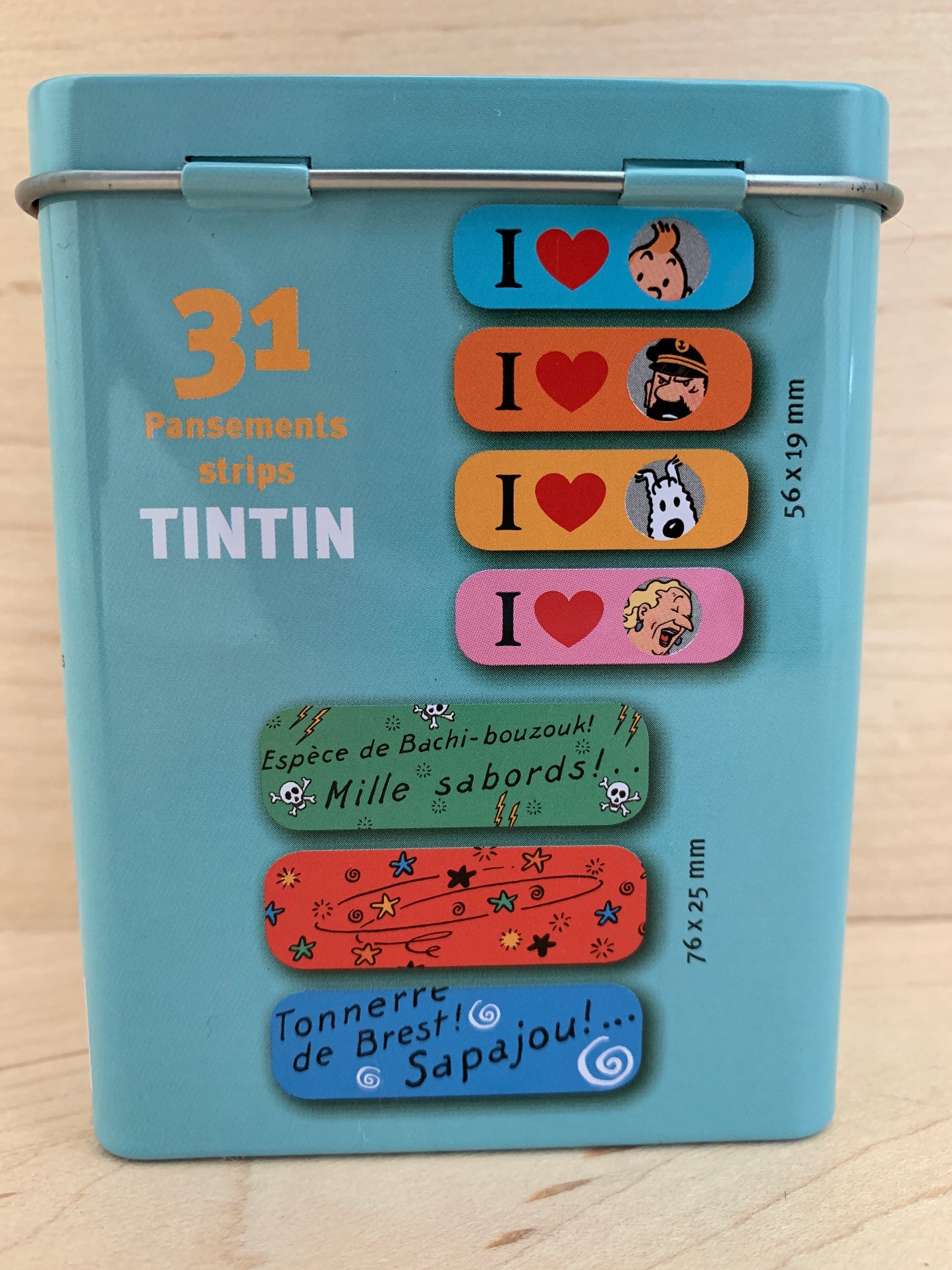 Tintin sticking-plasters tin box with 31 bandages, featuring colorful character designs and Captain Haddock's famous phrases