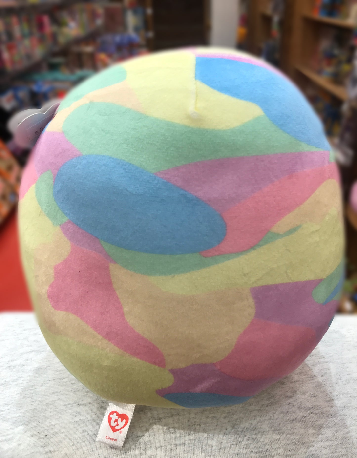 Ty Squish-a-Boo Cooper sloth plush in pastel camouflage pattern, soft and round shape, with Ty tag visible