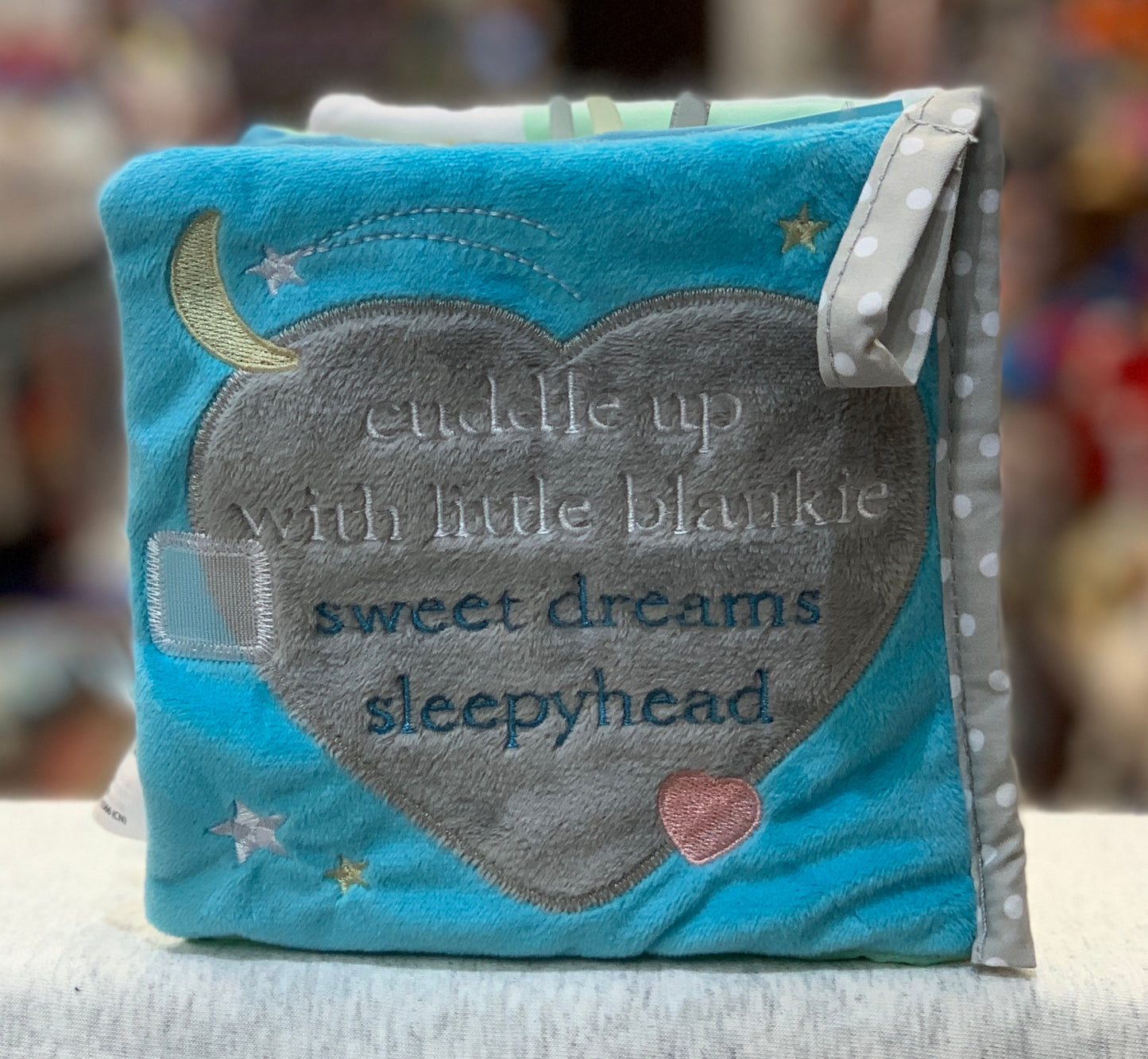 Soft baby activity book with blue cover, elephant design, and "cuddle up with little blankie sweet dreams sleepyhead" text
