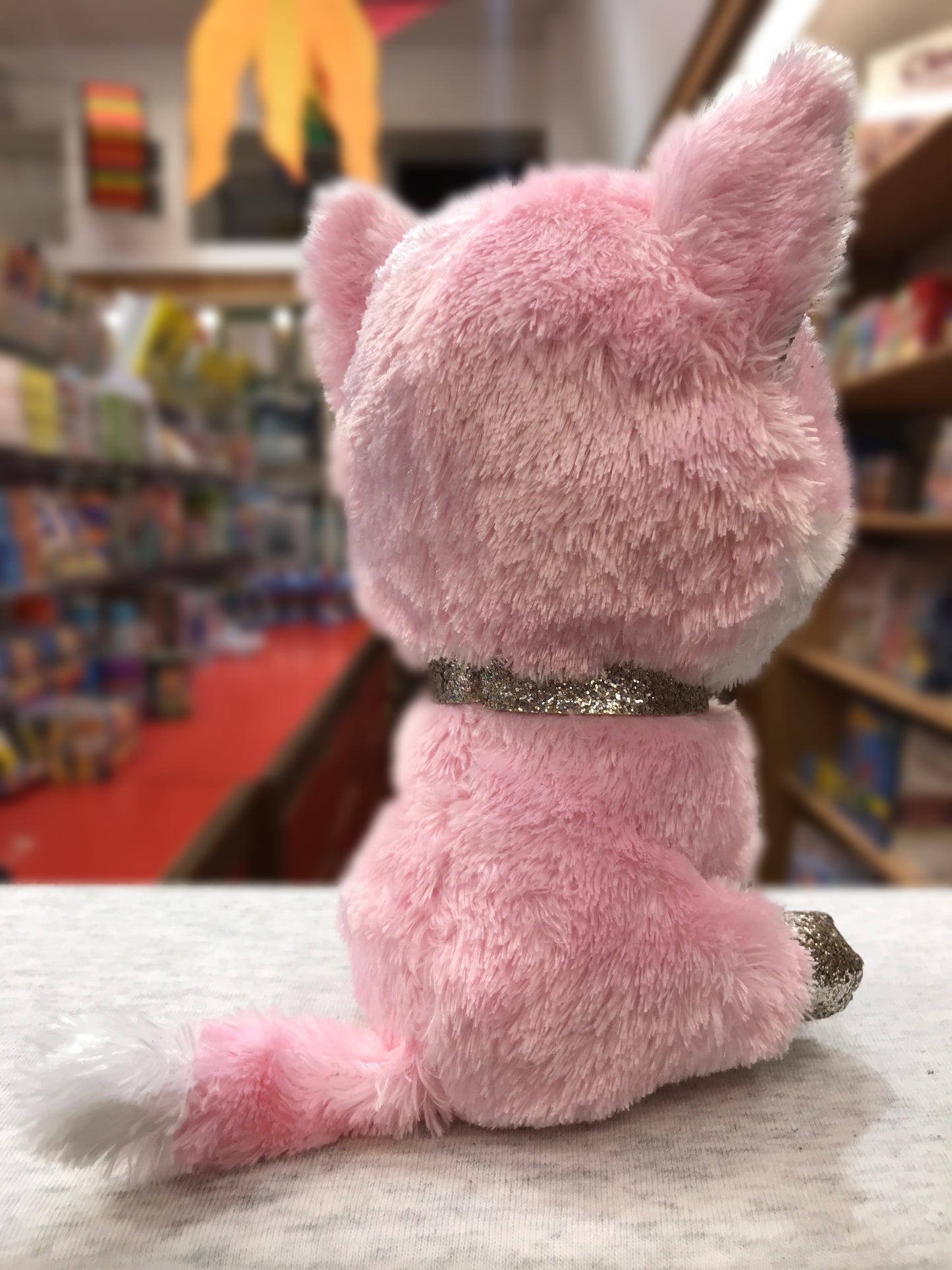 Ty Beanie Boo Fiona pink cat plush with glittery necklace, sitting in toy store display