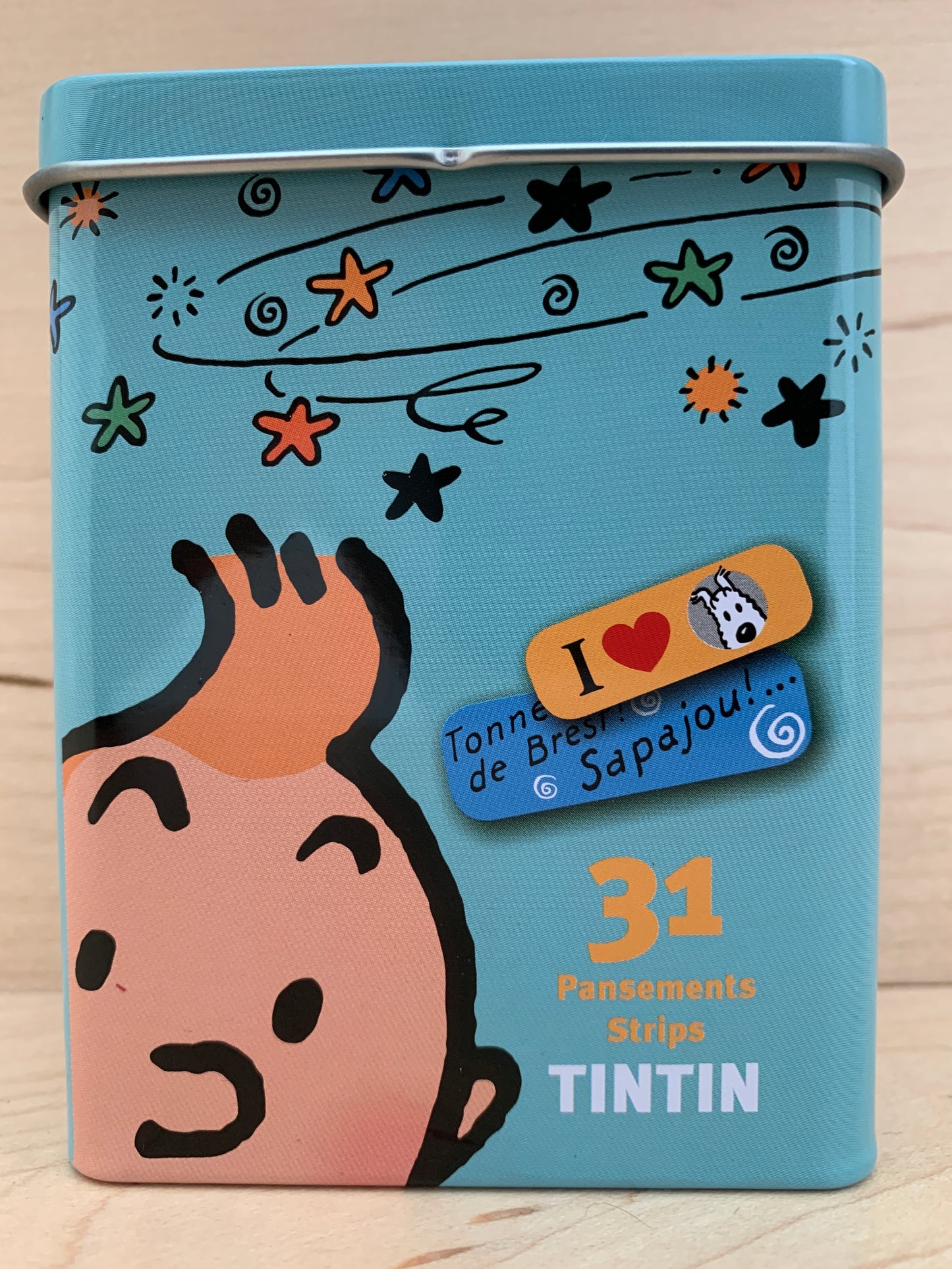 Tintin sticking-plasters tin box featuring Captain Haddock, colorful stars, and French text. Contains 31 bandages in two sizes.