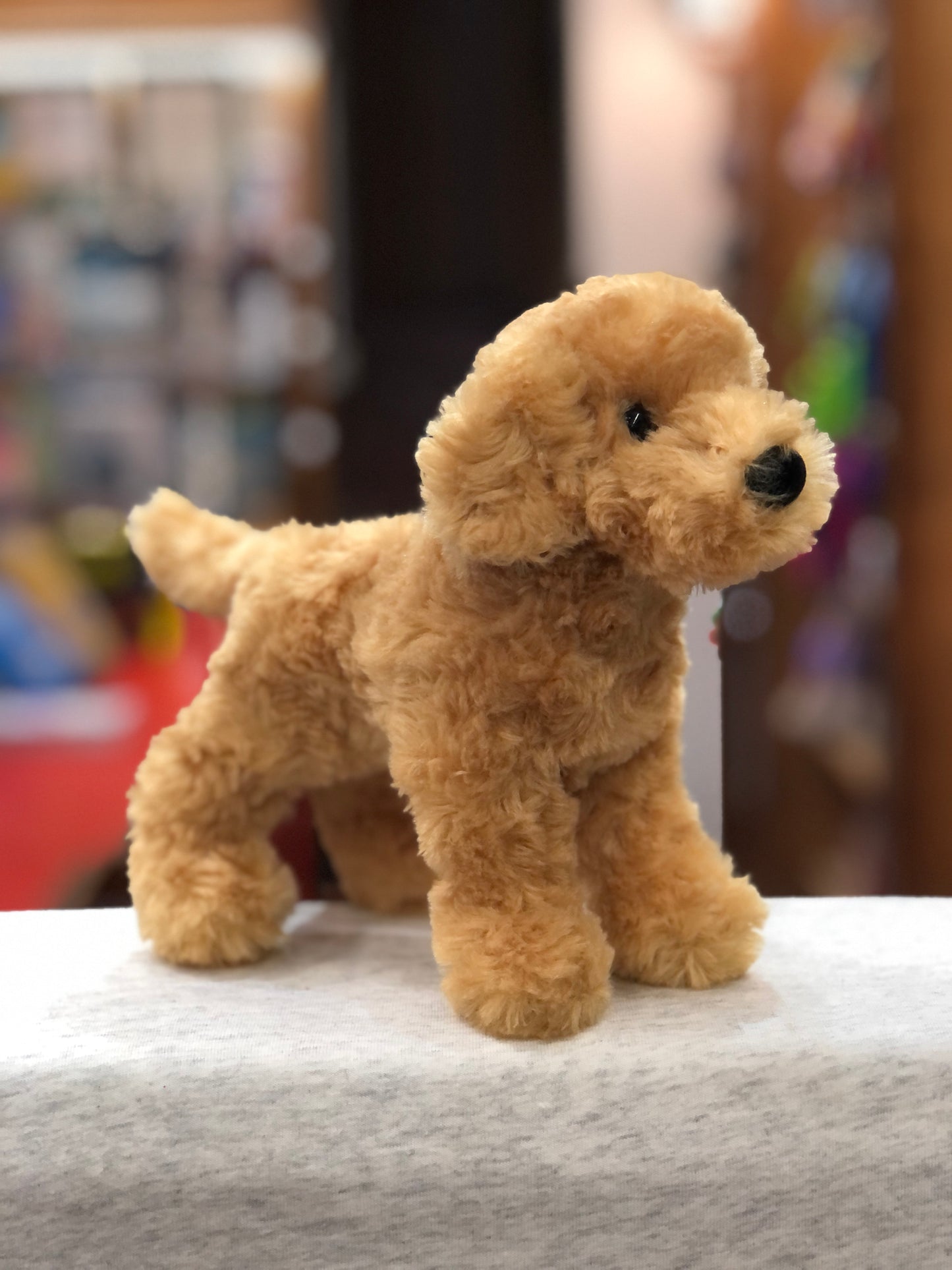Soft, cuddly 7.5" Golden Retriever plush toy standing on display, with fluffy golden fur and dark eyes