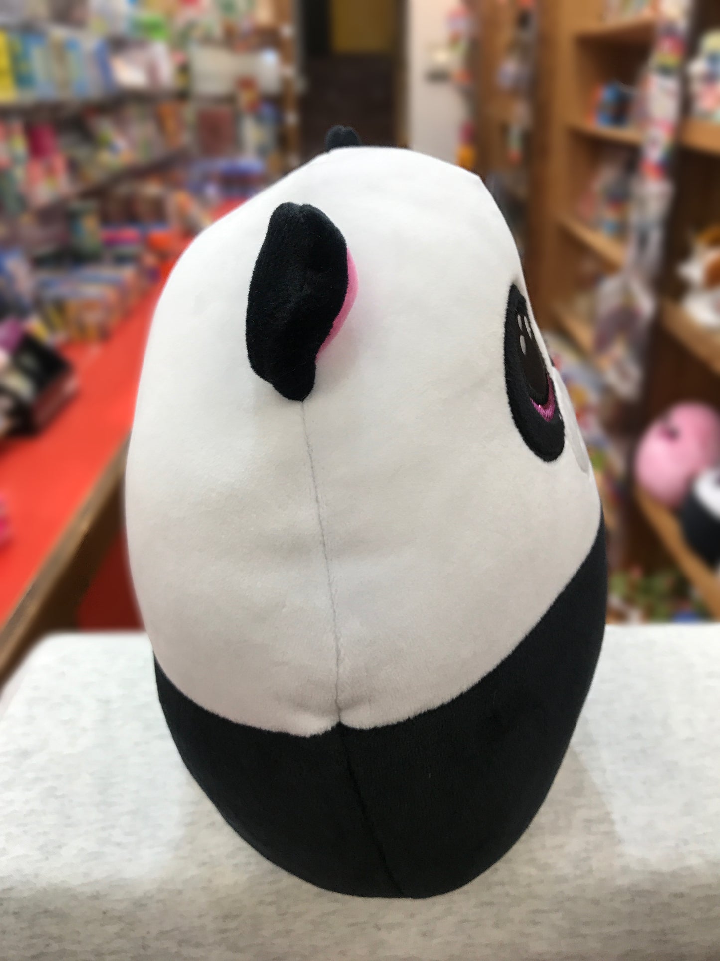 Soft Ty Squish-a-Boo panda plush with pink sparkle eyes, displayed in toy store, perfect for cuddling and travel
