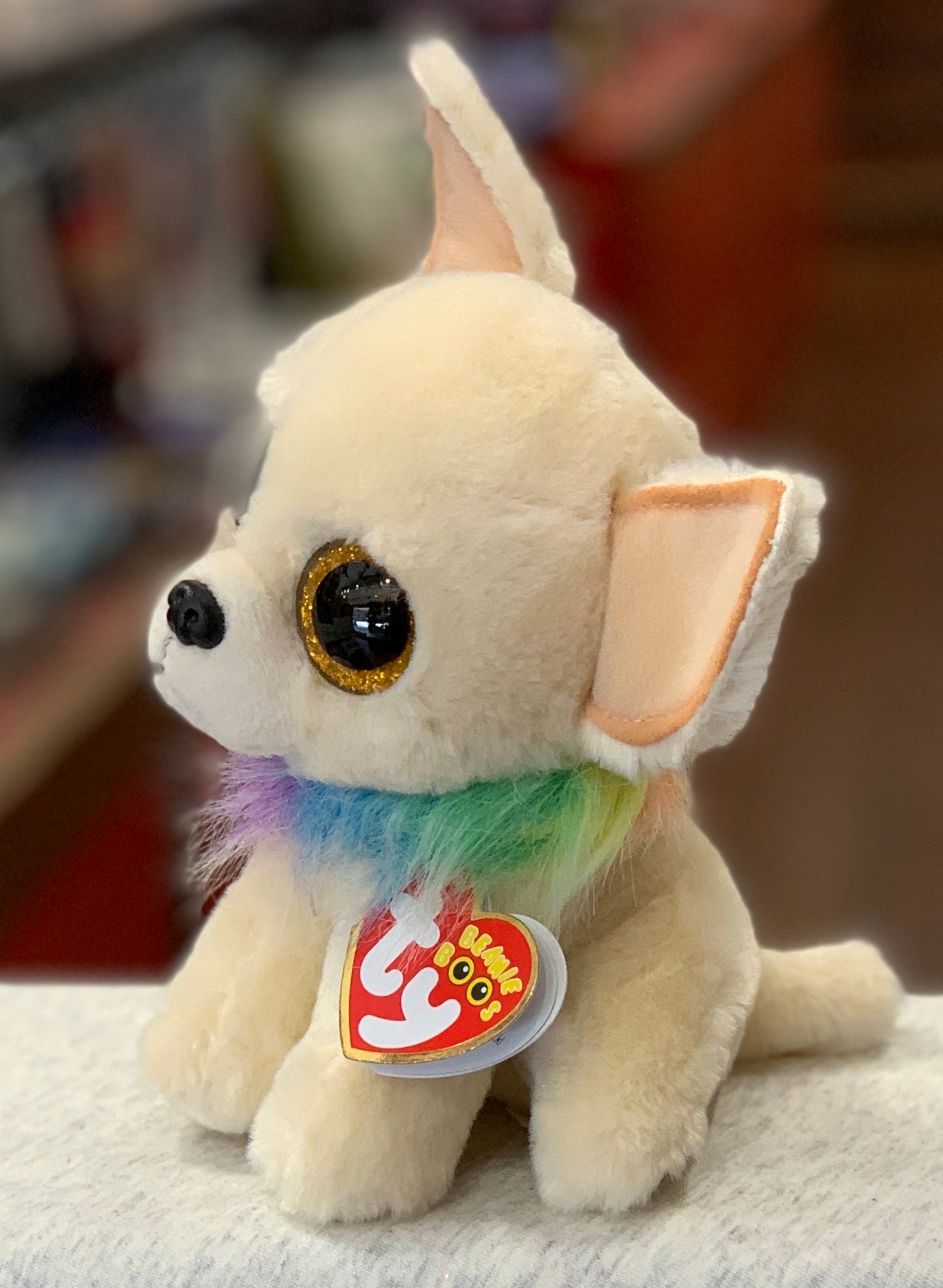 Ty Beanie Boo Chewey, tan Chihuahua plush with golden sparkle eyes and rainbow collar, soft 6-inch collectible toy