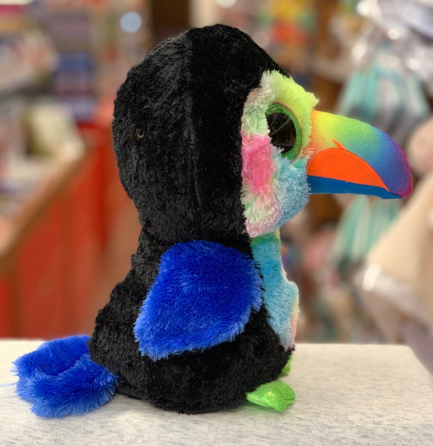 Colorful Ty Beanie Boo toucan plush with large eyes, vibrant beak, and soft multicolored fur, perfect for cuddling and collecting