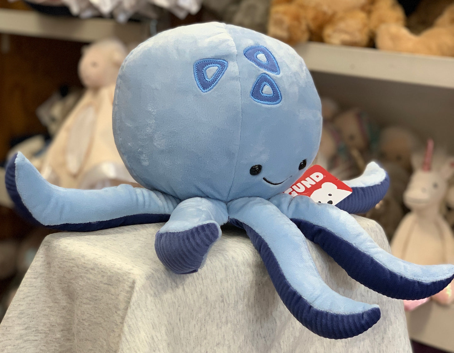 Gund Marley plush octopus toy, light blue with darker accents, smiling face, soft and cuddly design for kids