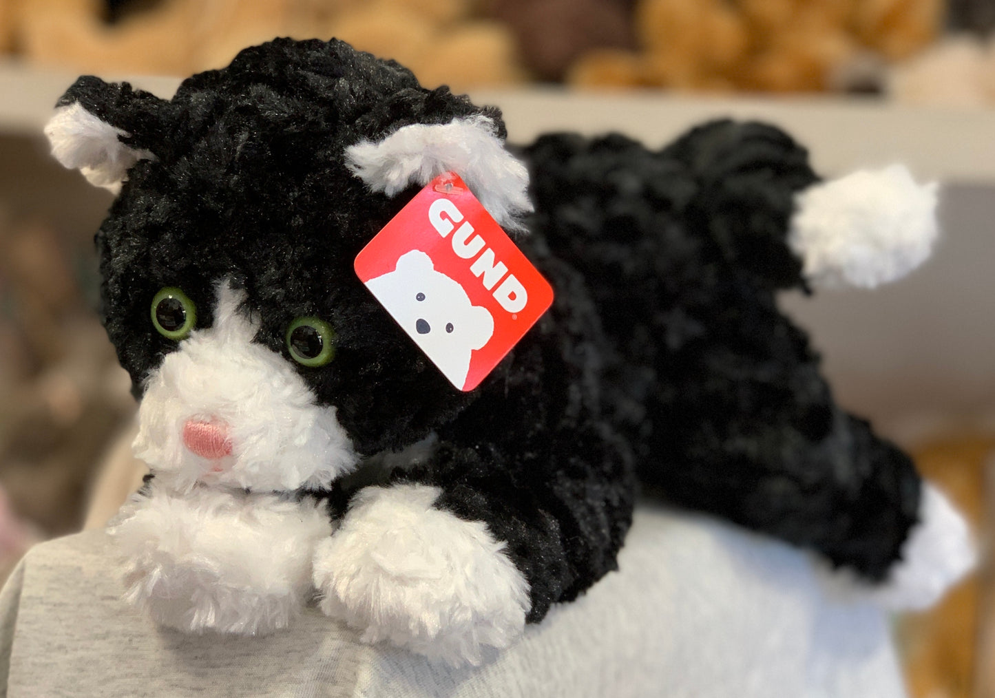 Gund Sebastian tuxedo cat plush toy with green eyes and red tag, 14-inch soft black and white stuffed animal