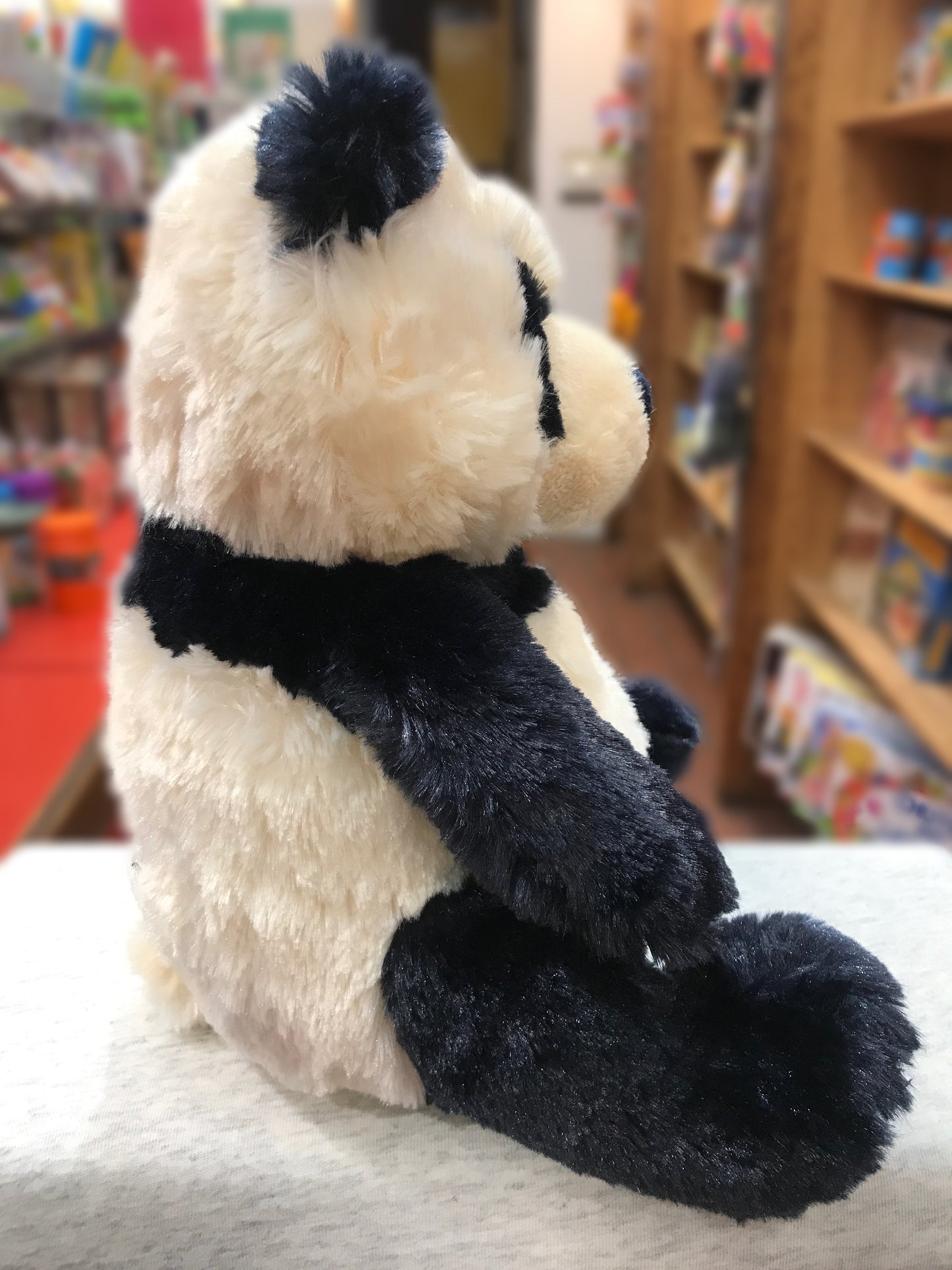 Gund Zibo panda plush toy, small 12-inch size, sitting on display in toy store with black and white fur