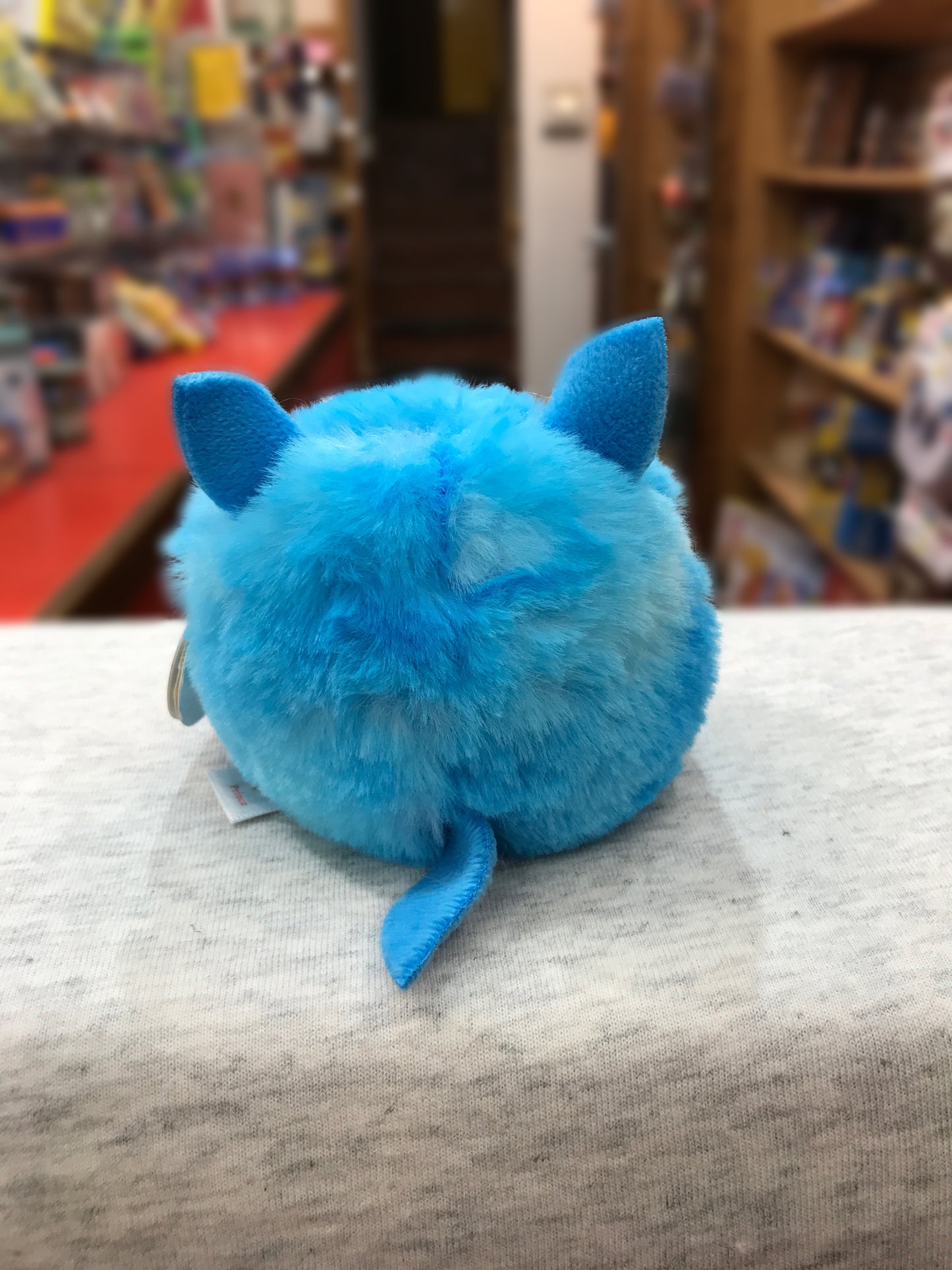 Ty Puffies Prince blue husky plush toy, round and fluffy, with pointed ears and tail, on display in toy store
