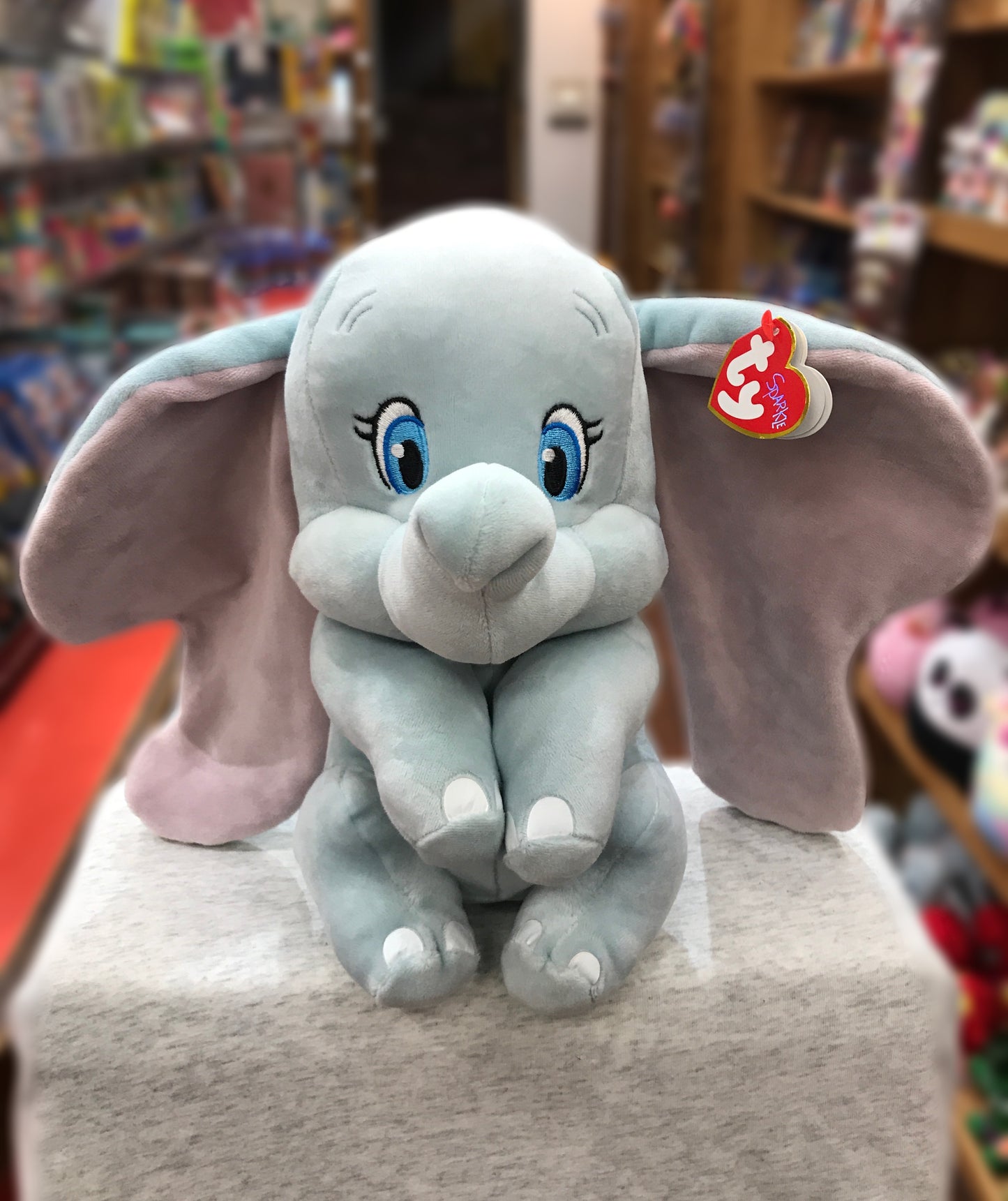Soft Ty Sparkle Dumbo plush toy with large ears and blue eyes, sitting in a toy store display