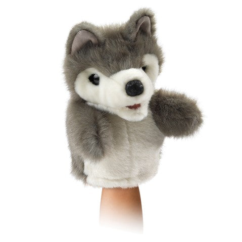 Folkmanis Little Wolf hand puppet with gray fur, white face, and movable mouth on person's hand
