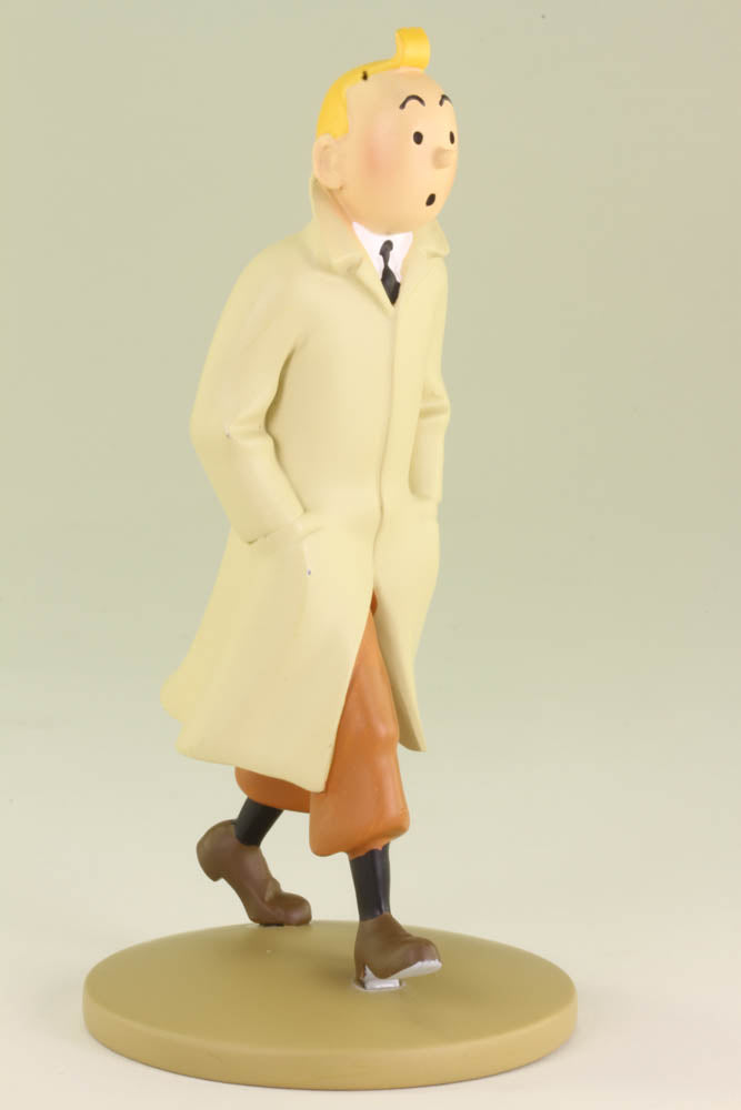 In deep contemplation over a mystery, Tintin walks the streets of an exotic city in his iconic trench coat.   The resin figure of Tintin in his trench coat is 14.5cm (6.6") tall and the base is 5.70cm (2.6") across. Comes packed in a sturdy clear plastic box. 