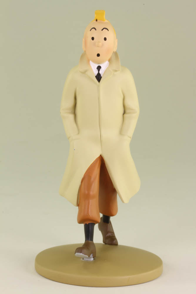 Tintin resin figurine in iconic trench coat, walking contemplatively on circular base, 12cm collectible statue