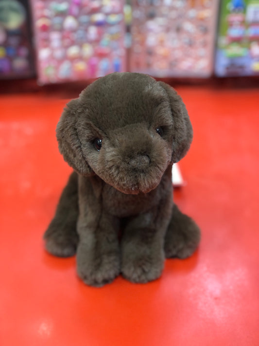 Adorable chocolate Labrador puppy plush toy sitting on red surface, soft and cuddly 6-inch stuffed animal for kids