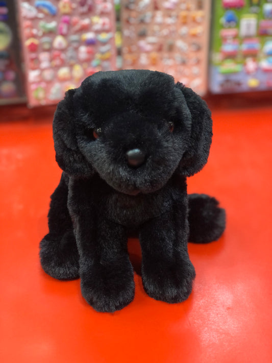 Adorable mini black Labrador plush toy Hattie sitting on red surface, soft and cuddly 6-inch stuffed animal for kids