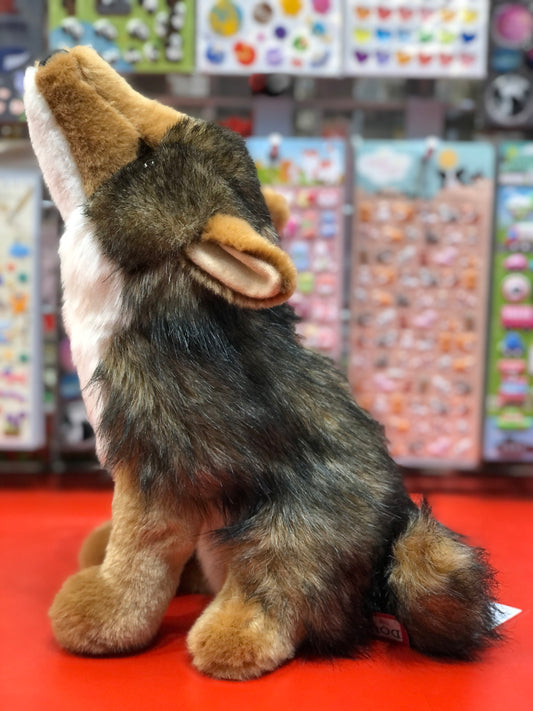 Realistic 11" Douglas Rambler Coyote plush toy howling, with gray-brown fur and chestnut snout, on red display surface
