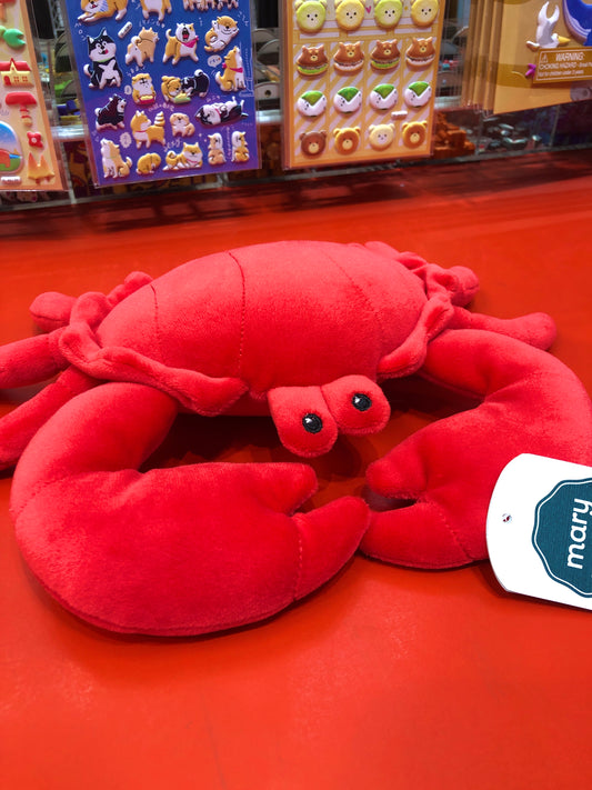 Soft, bright red Mary Meyer Smootheez crab plush toy with embroidered eyes on display, surrounded by other animal stickers
