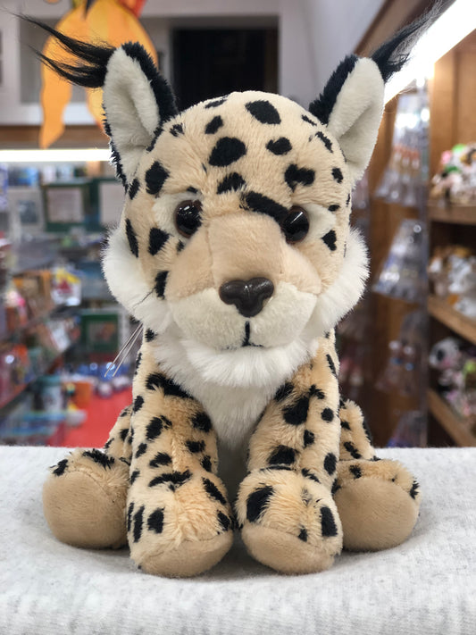 Soft, spotted Charlie Bears Cuddle Cub Lynx plush toy for babies, sitting on display in a store