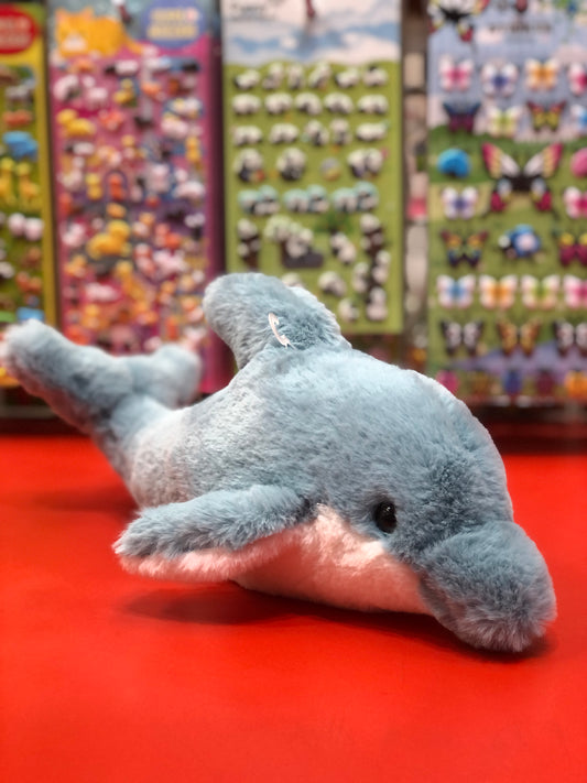Soft plush dolphin toy with realistic features on red display, colorful stuffed animal backdrop