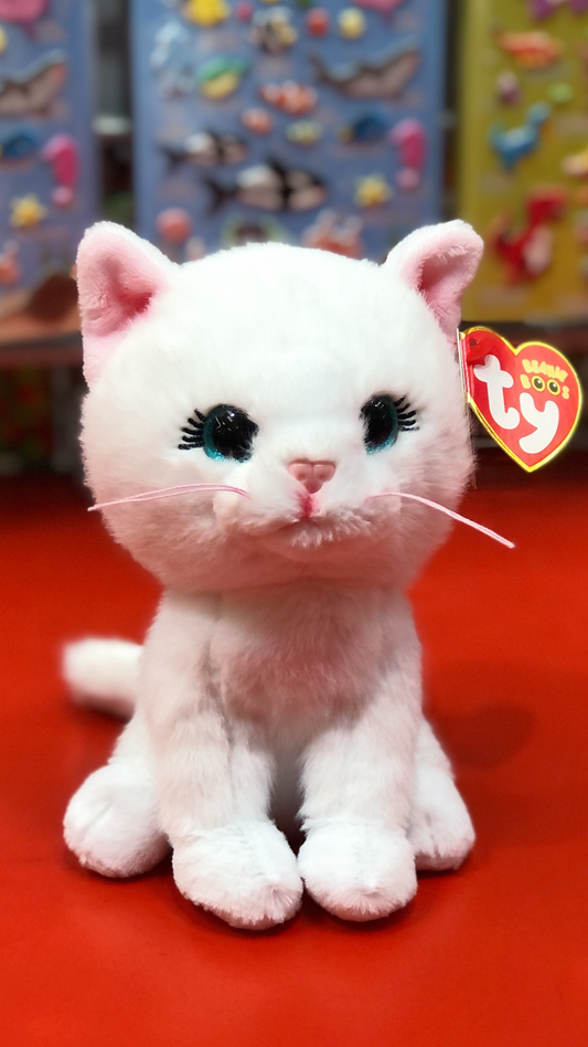 White Ty plush cat toy with black eyes and pink nose on a red surface, with a colorful background.