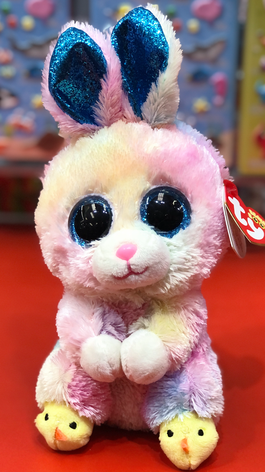 Ty plush toy with blue and pink colors on a red background