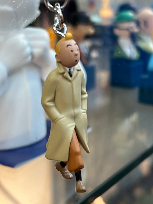Tintin keychain figurine in beige trench coat walking with hands in pockets, attached to metal key ring