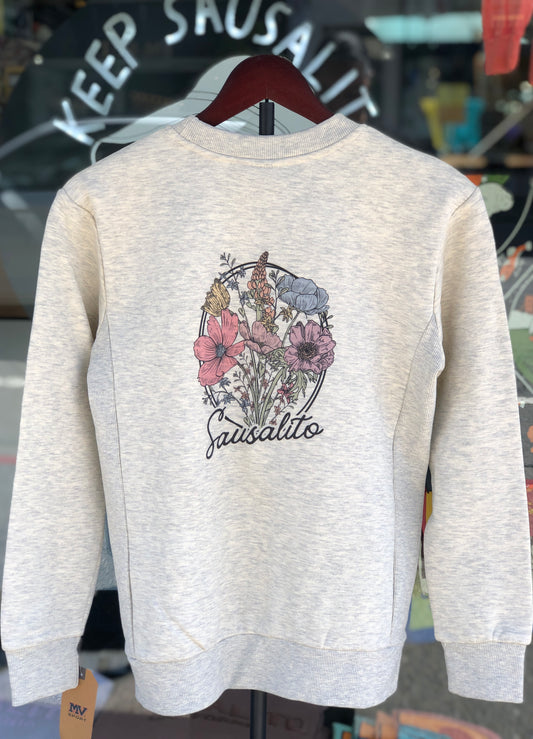 Oatmeal-colored women's fleece sweater featuring a circular pastel wildflower bouquet on the back
