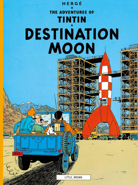 Front cover of The Adventures of Tintin: Destination Moon by Hergé. Little, Brown and Company paperback edition. Features the iconic red and white checkered moon rocket and the Syldavian space center.