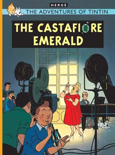 Front cover of the hardcover comic book "The Adventures of Tintin: The Castafiore Emerald" by Hergé. The colorful illustration depicts opera singer Bianca Castafiore in a bright red dress singing passionately into a microphone under bright studio lights. In the foreground, Tintin in a blue sweater holds a finger to his lips, hushing a group of news reporters and camera crew gathered around a piano inside Marlinspike Hall.