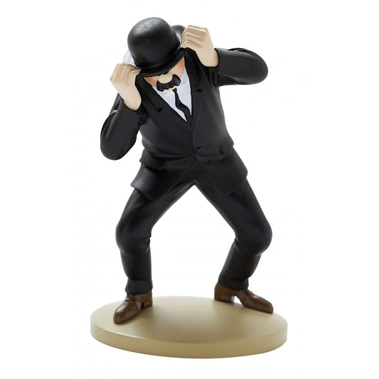 A hand-painted 12cm resin figure of Detective Thompson from Tintin, dressed in a black suit, white shirt, black tie, and brown shoes. He is standing on a circular beige base in an awkward, wide-legged crouching stance, using both hands to lift his black bowler hat slightly off his face, revealing his distinctive black walrus mustache.