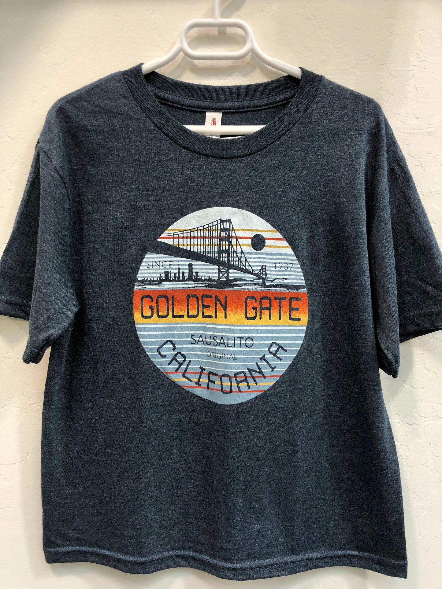 Golden Gate Bridge kids' t-shirt with circular sunset design featuring San Francisco skyline and Sausalito text