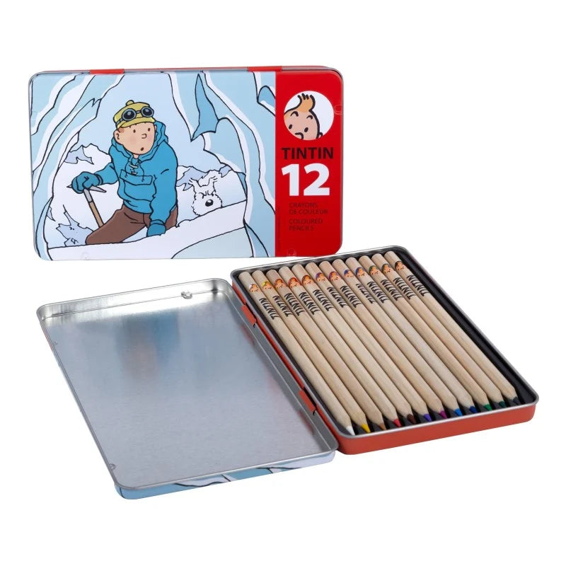 Open collectible metal tin featuring artwork from Tintin in Tibet on the lid, revealing twelve wooden colored pencils nestled inside alongside an empty silver storage compartment.