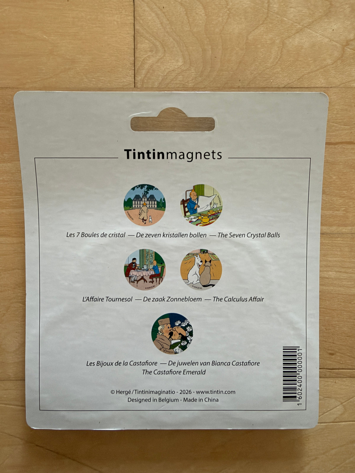 Back packaging of the Tintin magnets set displaying individual round metal magnets featuring artwork from The Seven Crystal Balls, The Calculus Affair, and The Castafiore Emerald.