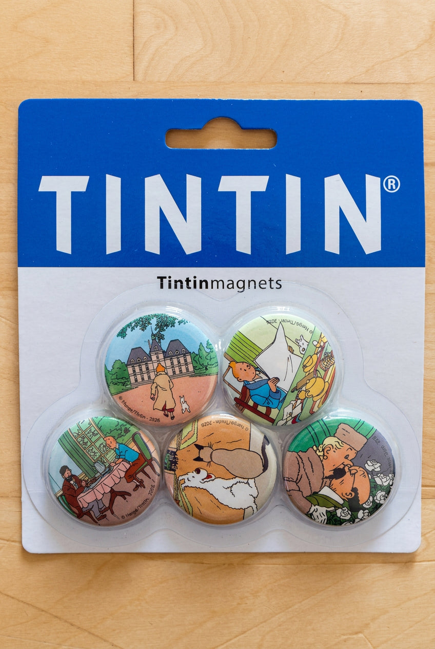Packaging of the Tintin Magnets Set of Five showing five round 1-inch metal magnets featuring artwork from The Adventures of Tintin displayed on a blue and white backing card.