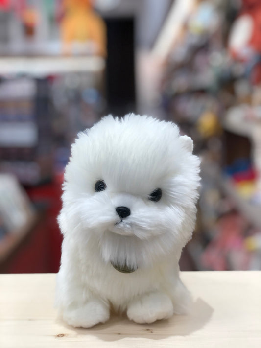 Adorable white Aurora Miyoni Tots Pompom Pup plush toy, 9 inches tall, with fluffy fur and cute black eyes, sitting on display