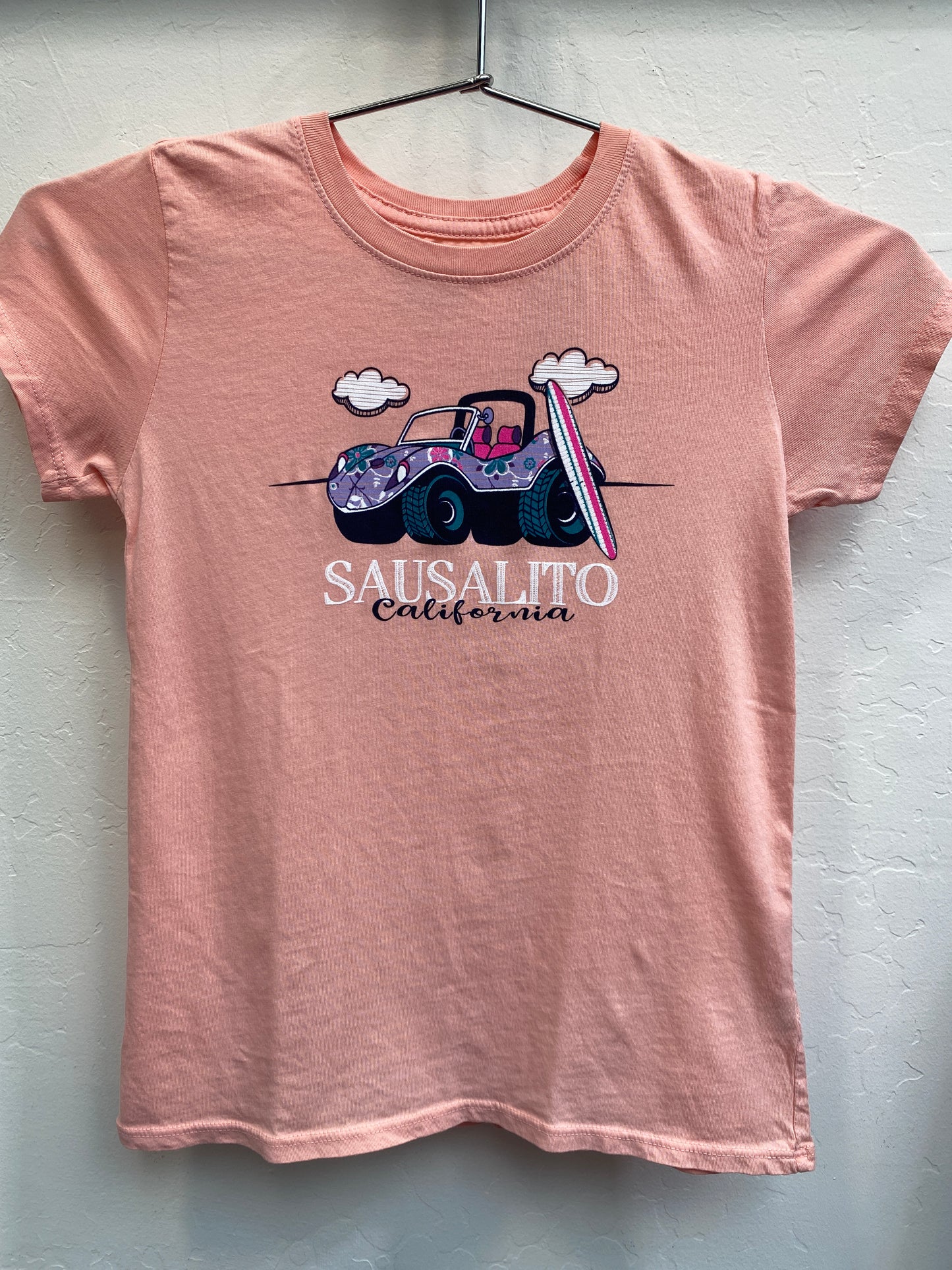 Pink kids' t-shirt with floral beach buggy and surfboard design, Sausalito California text, cotton garment-dyed