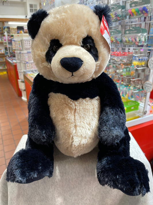 Gund Zi-Bo panda plush toy with unique navy and cream coloring, sitting in a toy store display