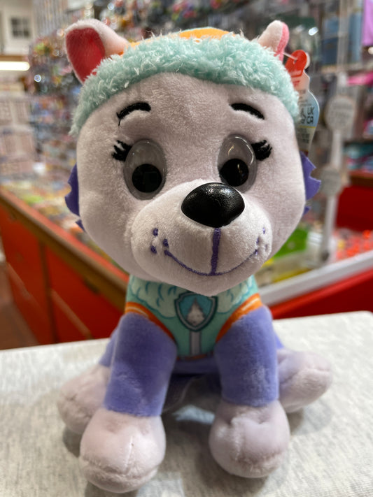 Gund Paw Patrol Everest plush toy with teal hat, purple uniform, and smiling face on store shelf