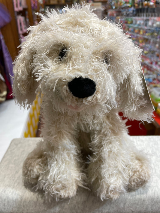 Gund Designer Pups Karina Labradoodle plush toy with fluffy white fur, black nose, and realistic features, displayed in a store setting