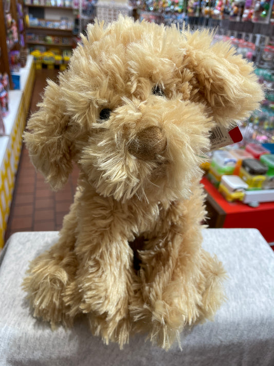 Gund Nayla Cockapoo plush toy, fluffy beige dog with realistic features, sitting in toy store display