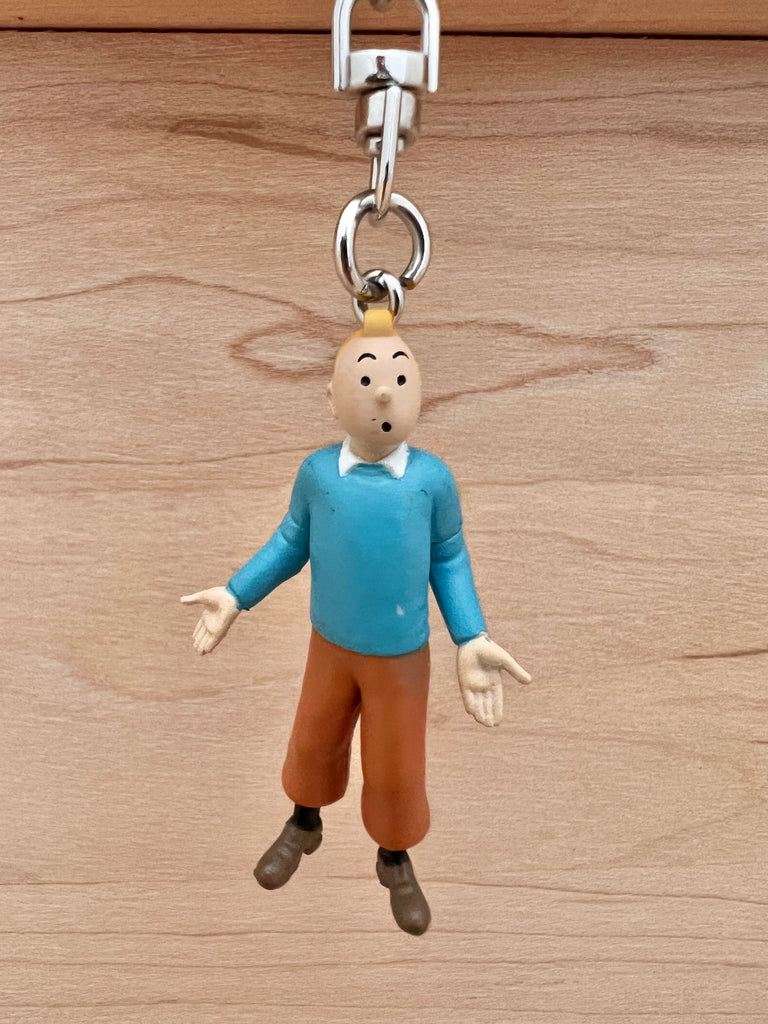 Tintin in blue sweater keychain.  Durable PVC construction. Figure is 5.5cm (2.2"). Overall length including the key chain is 11.4cm (4.5").   