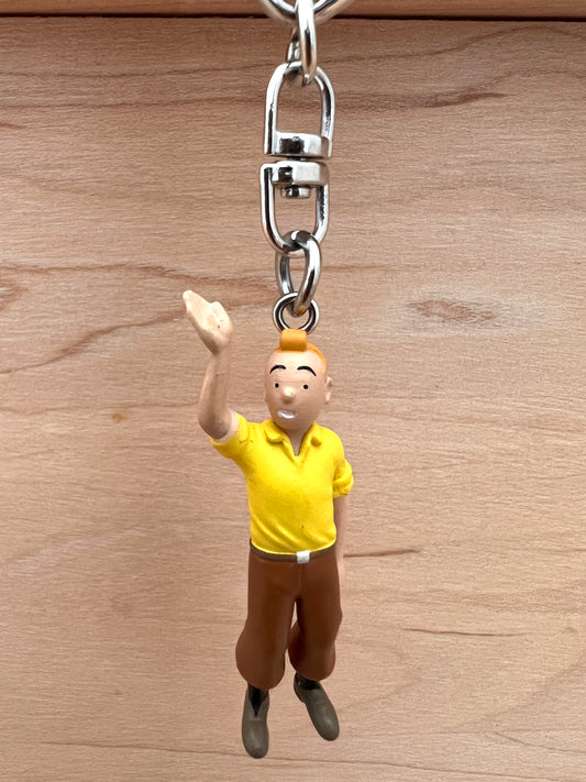 Tintin waving keychain with 6cm PVC figure in yellow shirt and brown pants, attached to metal key ring