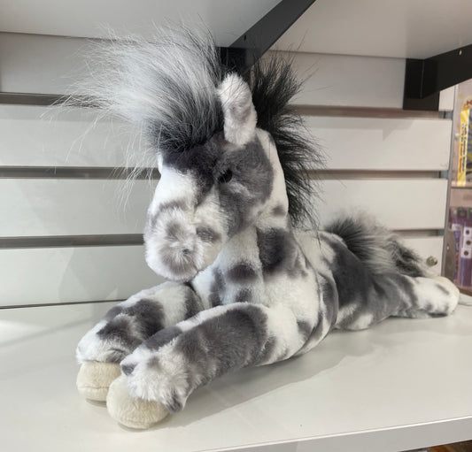 Plush Appaloosa horse toy with gray spots, fluffy mane and tail, lying on shelf, 15-inch stuffed animal for cuddling and play